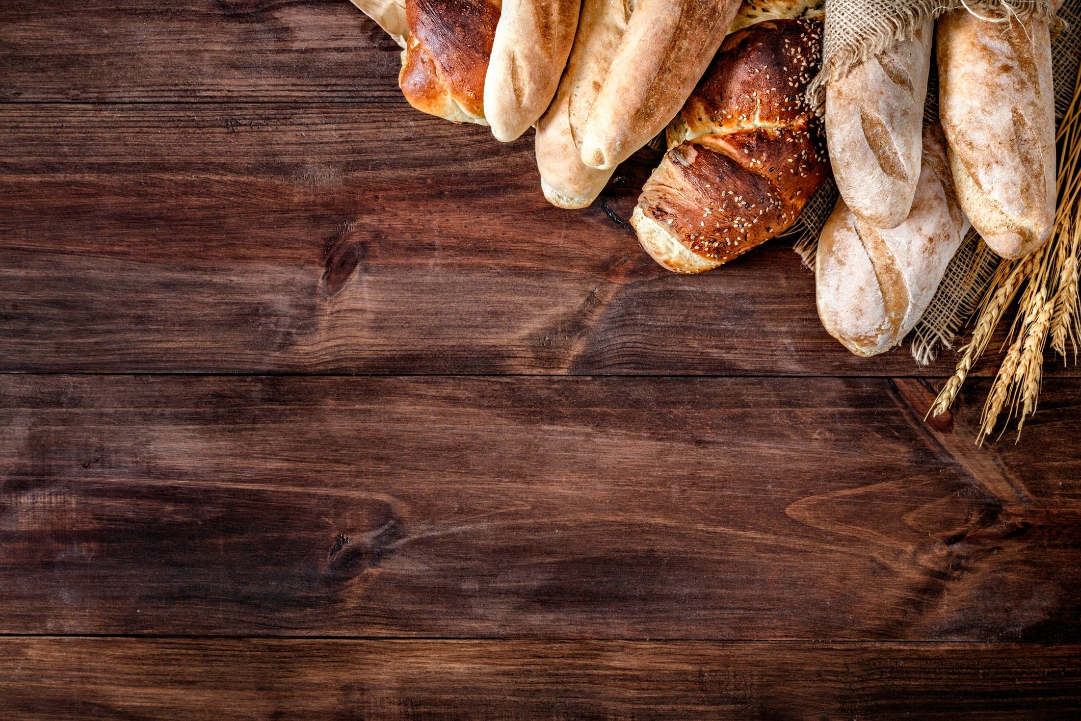 Assorted fresh breads and rolls arranged on a rustic table with copy space