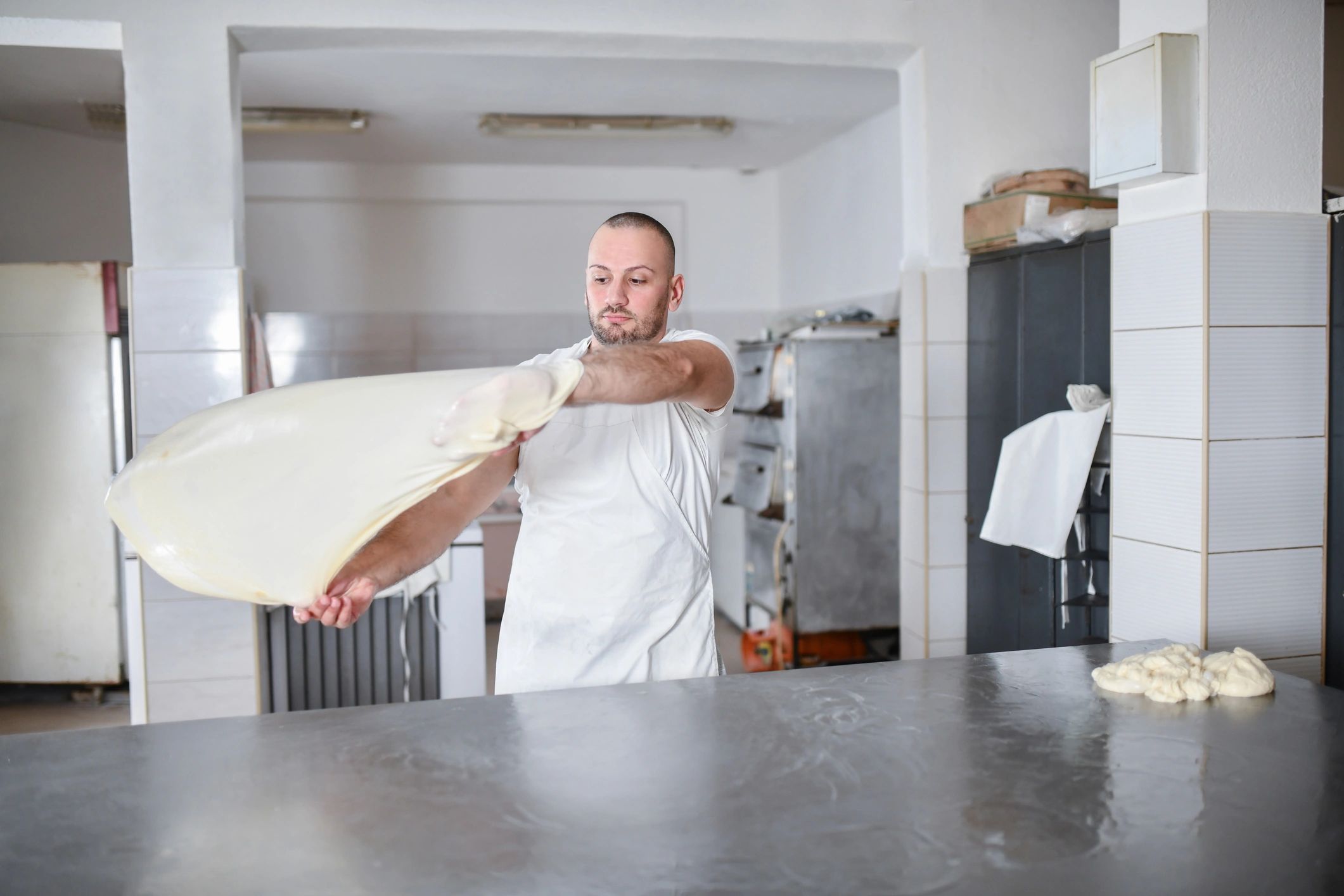 Baker hands working dough on a floured surface