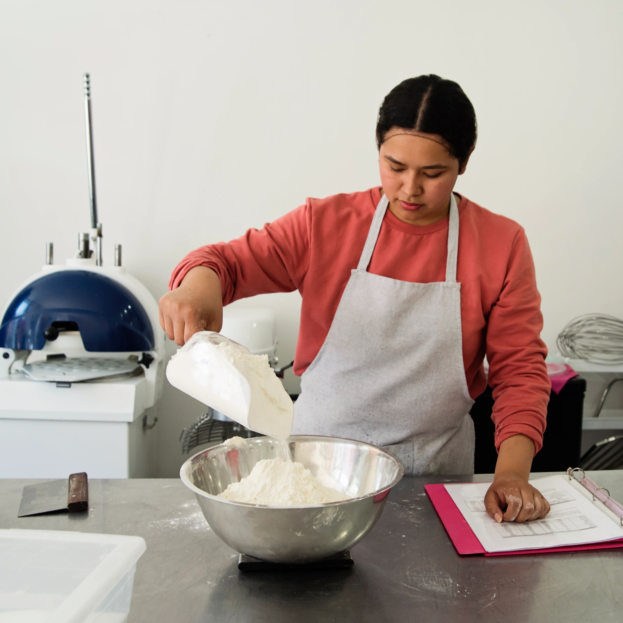 Bakery employee preparing pastries at a counter
