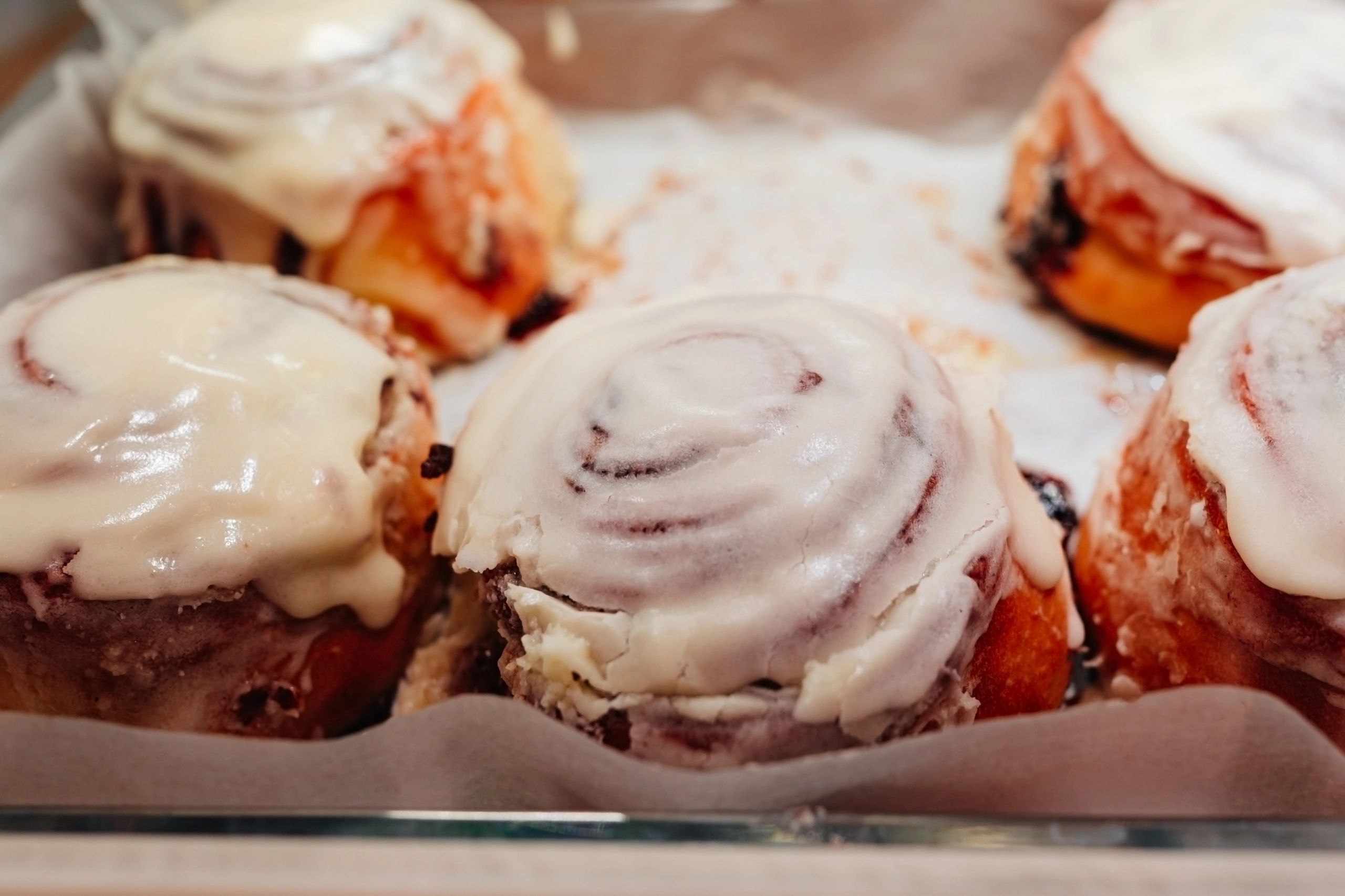 Glazed cinnamon buns on a counter
